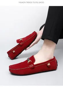 Gros plan de mocassins en daim rouge pour hommes avec détails de surpiqûres contrastées.