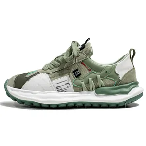Niche green and white low-top sports sneaker with chunky dissolved sole for men.
