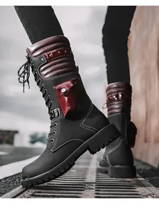 Detail shot of men's gothic punk combat boots with pocket and studs on street grate