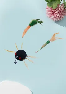 Macro view of colorful simulated insect cat teaser wand replacements with feathers and bells
