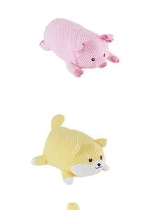 Close-up detail of textured pink pig and yellow Shiba Inu plush dog molar pet toys