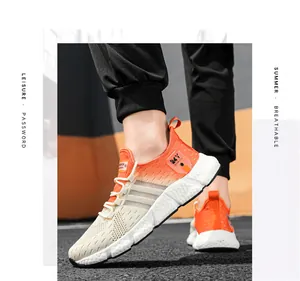 Side view of breathable orange gradient knit sneakers for men with cushioned soles
