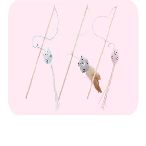 Detail view of three cartoon plush cat teaser wands with wooden poles and feathers
