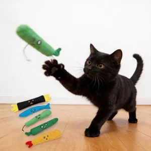 Playful black cat catching a colorful plush catnip toy from the cuisine collection set