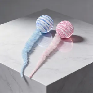 Dettaglio di palline per gatti marmorizzate con code di bruco in peluche morbido.