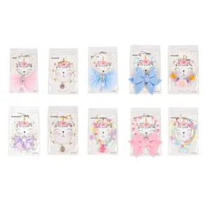 Detailed view of ten colorful pet collars with pearls, beads, and large bows on display cards.