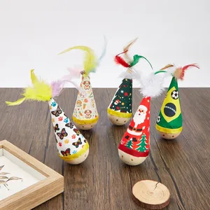 Macro view of five colorful tumbler cat toys with feathers and varied festive motifs
