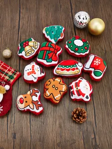 A collection of ten assorted festive plush Christmas pet toys displayed on a rustic wooden surface