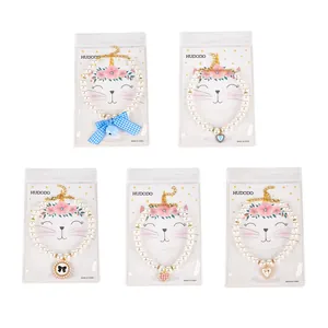 Five styles of elegant pet pearl collars with various decorative charms