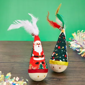 Detailed view of festive Christmas themed tumbler cat toys featuring colorful feathers and bells