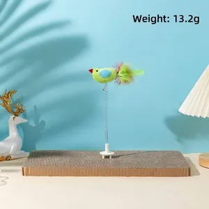 Detail view of the spring-mounted plush bird toy on a cardboard cat scratcher.