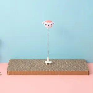Detailed view of cat spring toy with plush sheep head on cardboard scratching pad