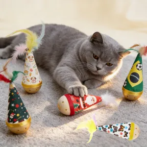 Interactive cat tumbler toy with colorful feathers shown in use with a playful gray cat.