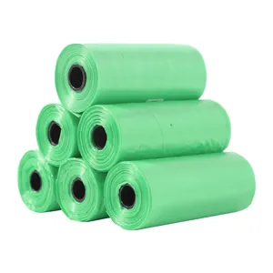 Detail view of stacked green plastic rolls of pet waste bags on a clean white background