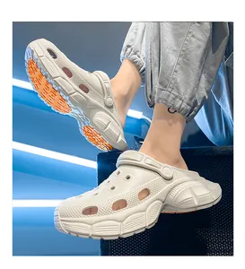 Close-up of stylish beige garden clogs with thick orange non-slip soles for summer