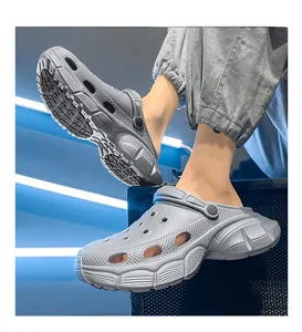Detail view of grey chunky clogs showing the thick textured sole and side profile