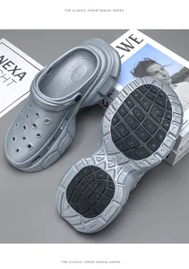 Detailed view of the chunky textured outsole and thick platform design of the grey clogs.