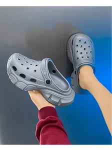 Close-up view of grey platform clogs showing the chunky sole and breathable holes