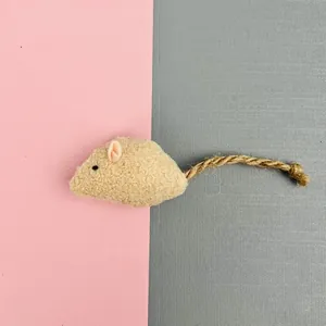 Macro view showing the soft fuzzy texture and sisal rope tail of the catnip mouse toy
