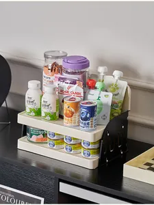 Cream and black two-tier desktop storage rack organized with various pet snacks and cans