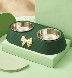 Detailed view of luxury double pet bowl with stainless steel inserts and gold bow detail