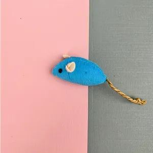 Detailed view of a blue corduroy catnip mouse toy featuring a long woven twine tail
