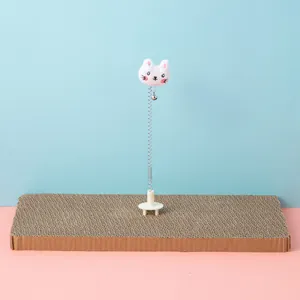 Macro view of a cat scratching board toy featuring a flexible spring and cute plush head