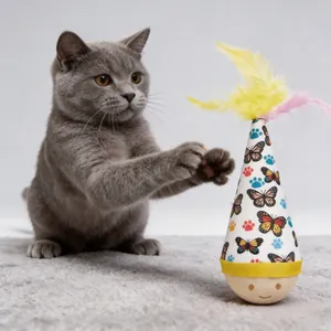 Interactive tumbler cat toy with colorful feathers and butterfly patterns shown with a cat
