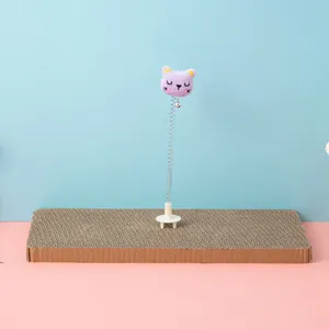Detail view of cat scratching board with spring plush cat toy attachment
