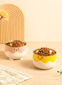 Cute cartoon stainless steel pet bowls with duck and cat face designs in lifestyle setting