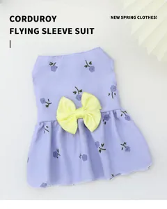 Detail of lavender floral pet dress with a large yellow bow and corduroy texture