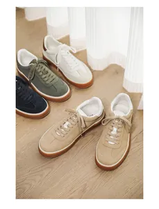 Collection of stylish men's suede sneakers in tan, navy, olive and off-white colors.
