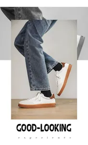 Close-up detail of men's white leather sneakers featuring brown suede heel and gum sole