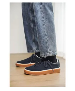 Detail view of navy suede men's sneakers with classic gum soles and denim styling.