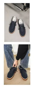 Navy blue suede men's sneakers featuring classic gum soles and white collar accents.