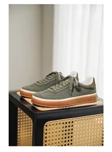 Detailed shot of premium olive green suede men's sneakers with classic gum soles