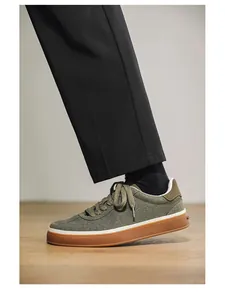 Side view close-up of men's olive green suede skate shoes with vintage gum soles