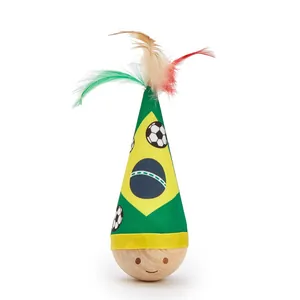 Close-up of Brazil themed tumbler cat toy with colorful feathers and wooden base