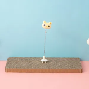 Interactive spring cat toy with a yellow plush head mounted on cardboard scratcher