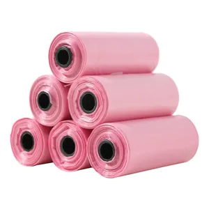Detail view of six rolls of pink biodegradable pet waste bags stacked on a white background.