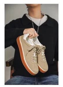 Close-up of premium suede men's sneakers with durable gum soles and white details