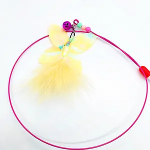 Detailed macro view of yellow feather butterfly cat teaser toy with bell and colorful beads