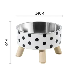 Elevated stainless steel pet bowl with black polka dot pattern and sturdy wooden legs