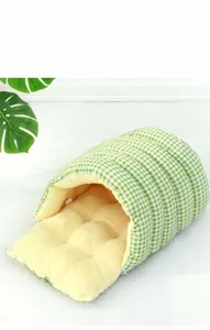 Detailed view of plush warm enclosed cat sleeping bag with green checkered pattern