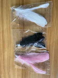 Close-up detail of three colorful feather cat teaser wand replacements with small bells