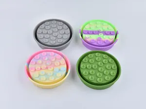 Detailed view of four silicone pet slow feeder bowls with suction cups in various colors.