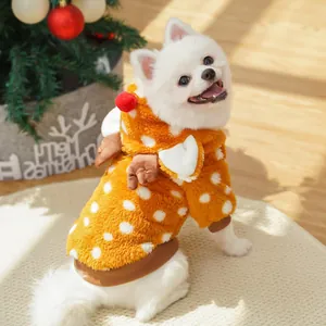 Close-up of a white dog wearing a cute orange reindeer plush hoodie for Christmas