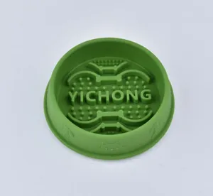 Detailed macro view of green silicone pet slow feeder bowl with bone pattern nubs