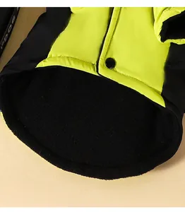 Macro detail of warm black fleece lining and snap button on neon yellow pet dog jacket
