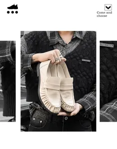 Premium beige crocodile-textured leather slip-on loafers held by a model in casual wear